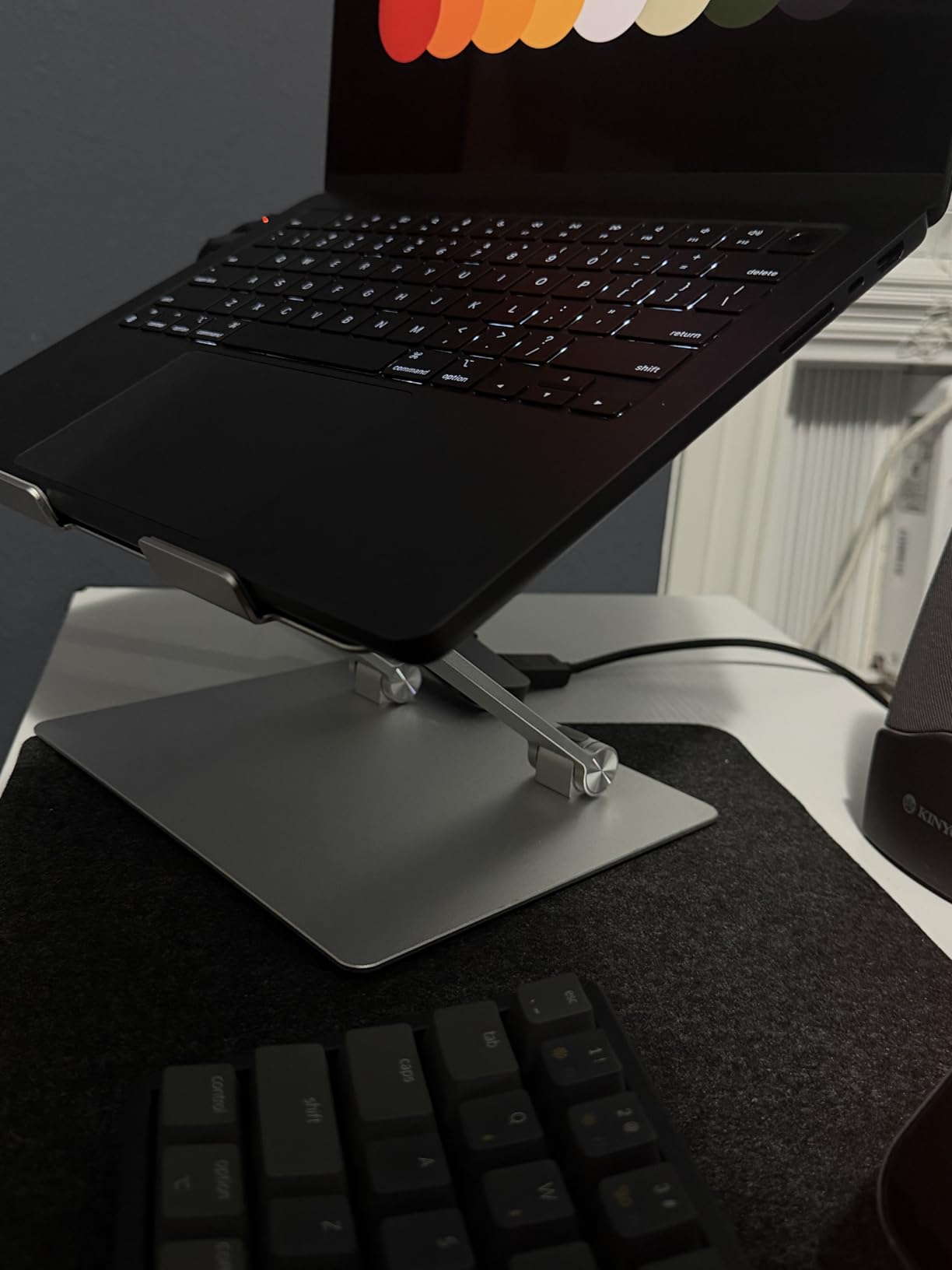 Amazon Basics Sturdy and Portable Ergonomic Laptop Stand for Desk, Height Adjustable Riser with Ventilated Cooling, Foldable, Fits all Laptops up to 15.6 Inch, Silver customer photo 2
