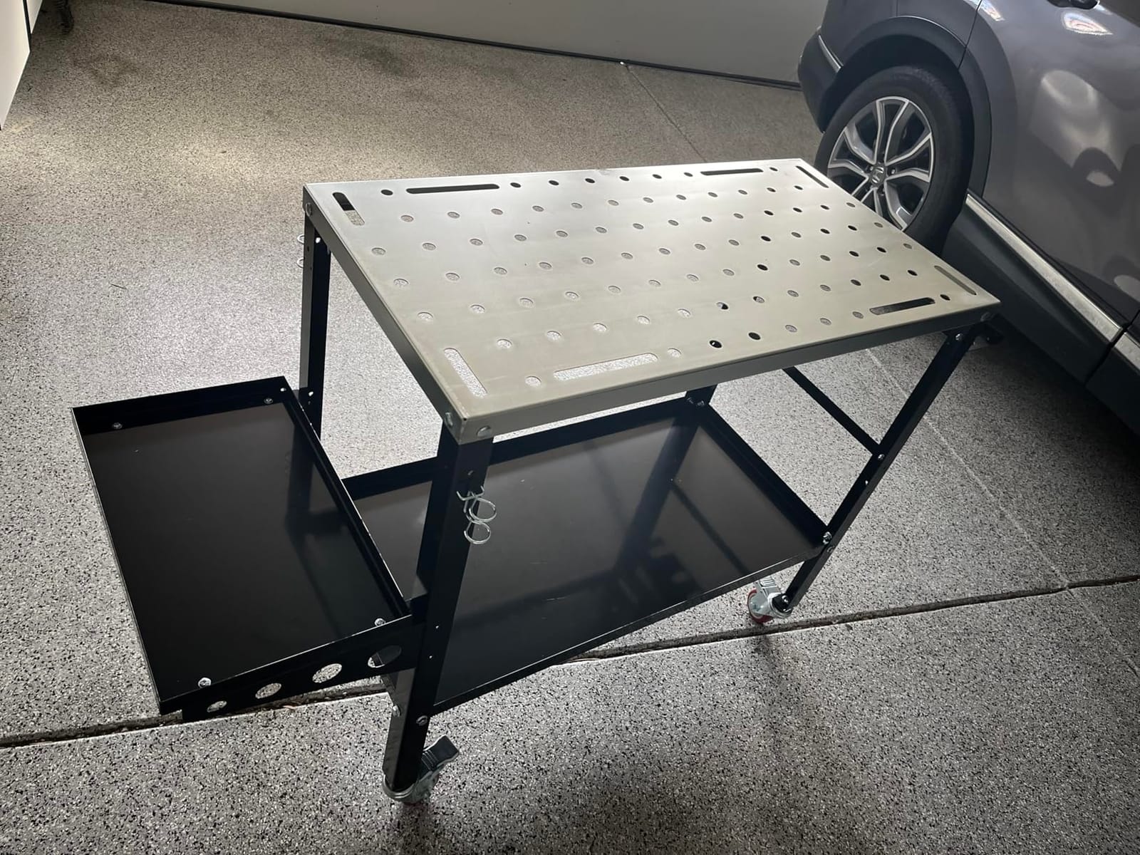 Goplus Rolling Welding Table, 1200 LBS Welding Workbench Table Top w/Lockable Wheels, Tool Rack & Tray, 144 5/8